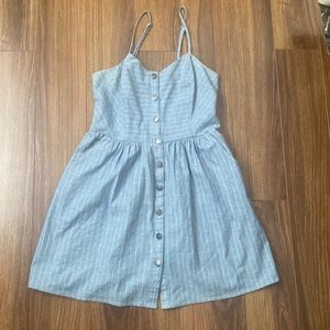 Blue dress with faint white strips and buttons.